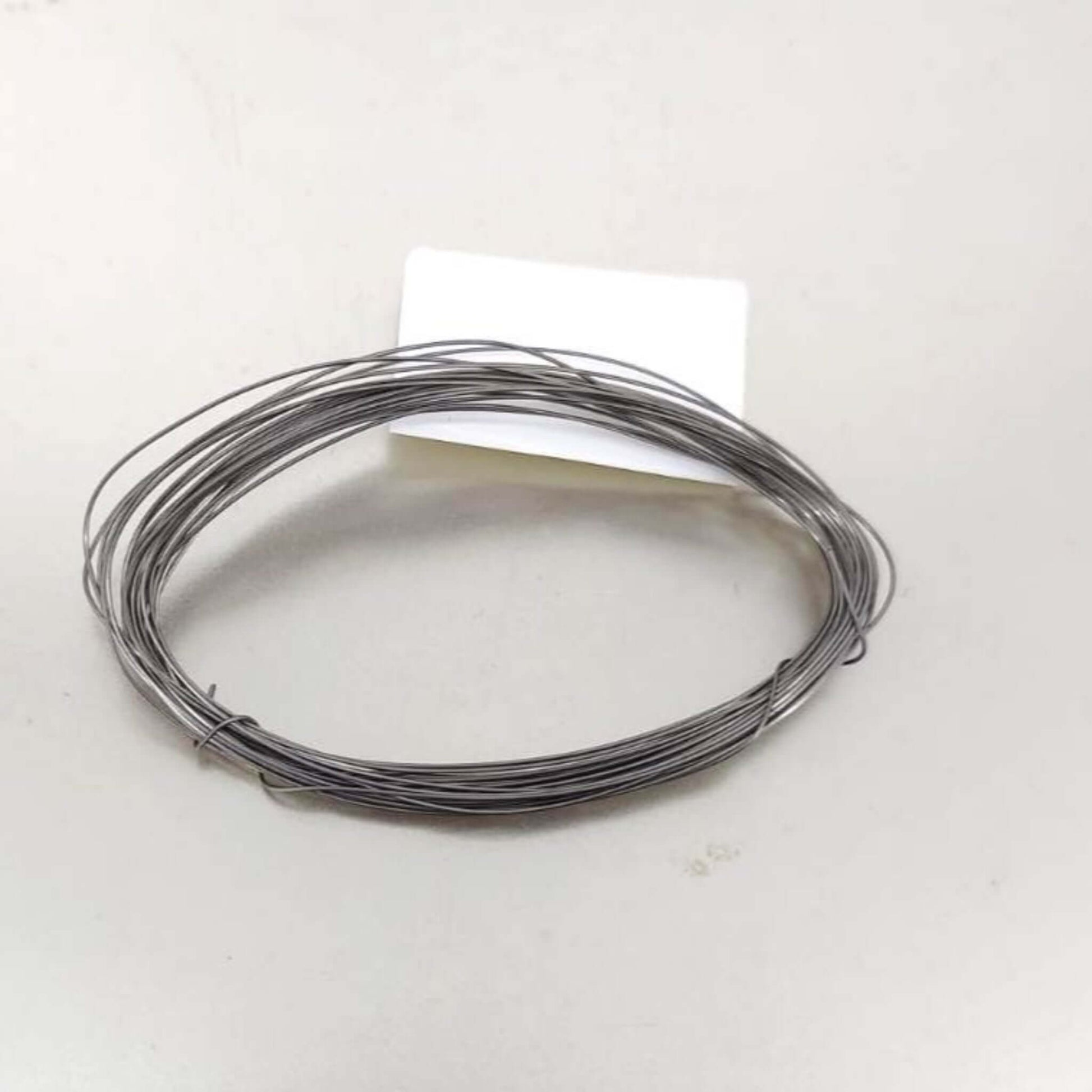 A coil of 0.4mm (26 AWG) alloy heating wire, 5 meters in length, on a white background.