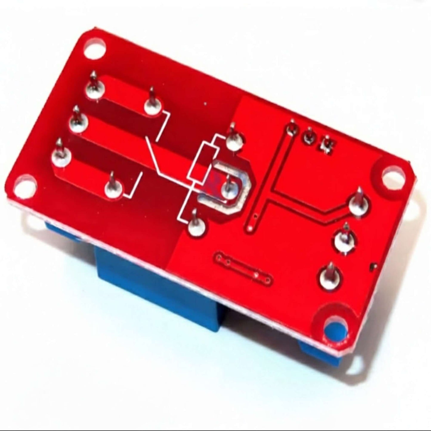 The bottom view of a red 1-channel relay module PCB, showing the solder joints and clean circuit traces.