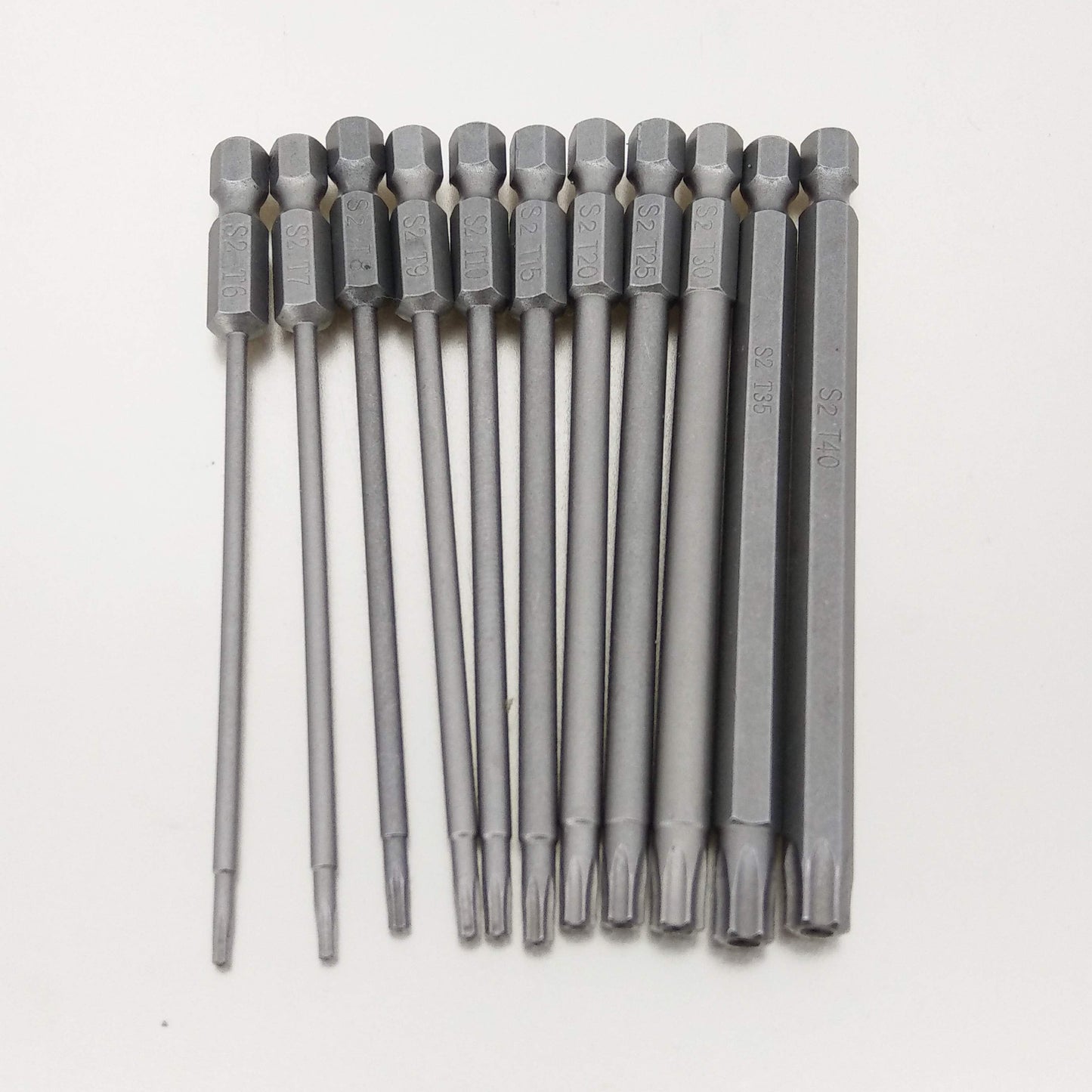 The full 11-piece set of 100mm magnetic S2 steel Torx screwdriver bits laid out in a row to show their full length.