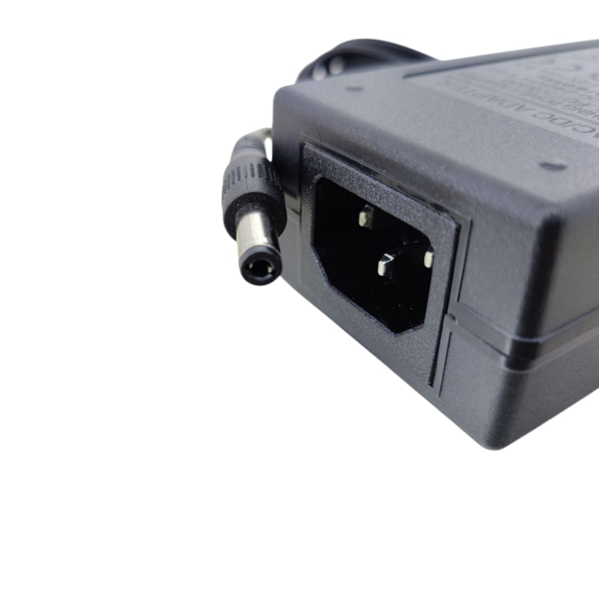Close-up of a 12V 5A universal AC/DC power adapter showing the plug and power input port.