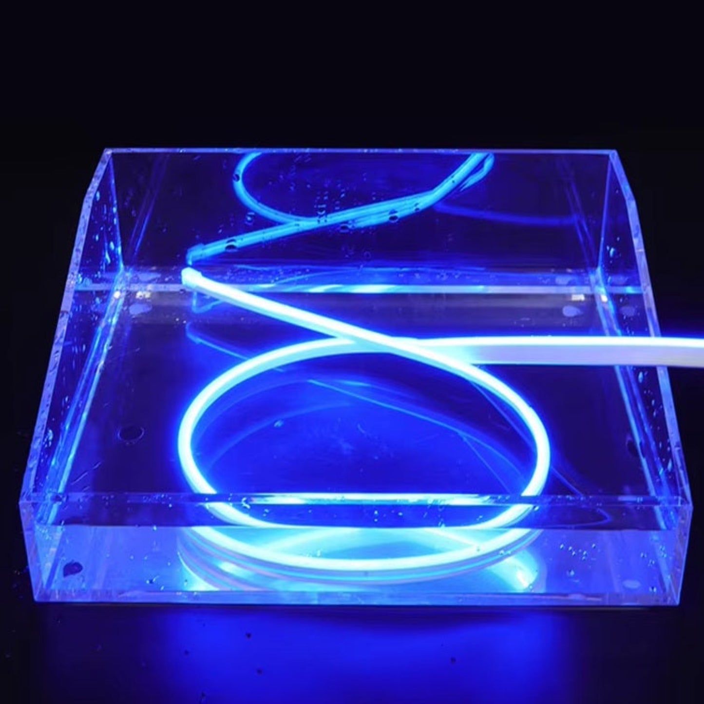 12V flexible LED neon strip in blue, shown submerged in water to highlight waterproof feature.