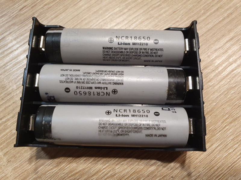 Three 18650 batteries (NCR18650 Li-Ion) inserted into a 3-slot black battery holder, demonstrating fit.