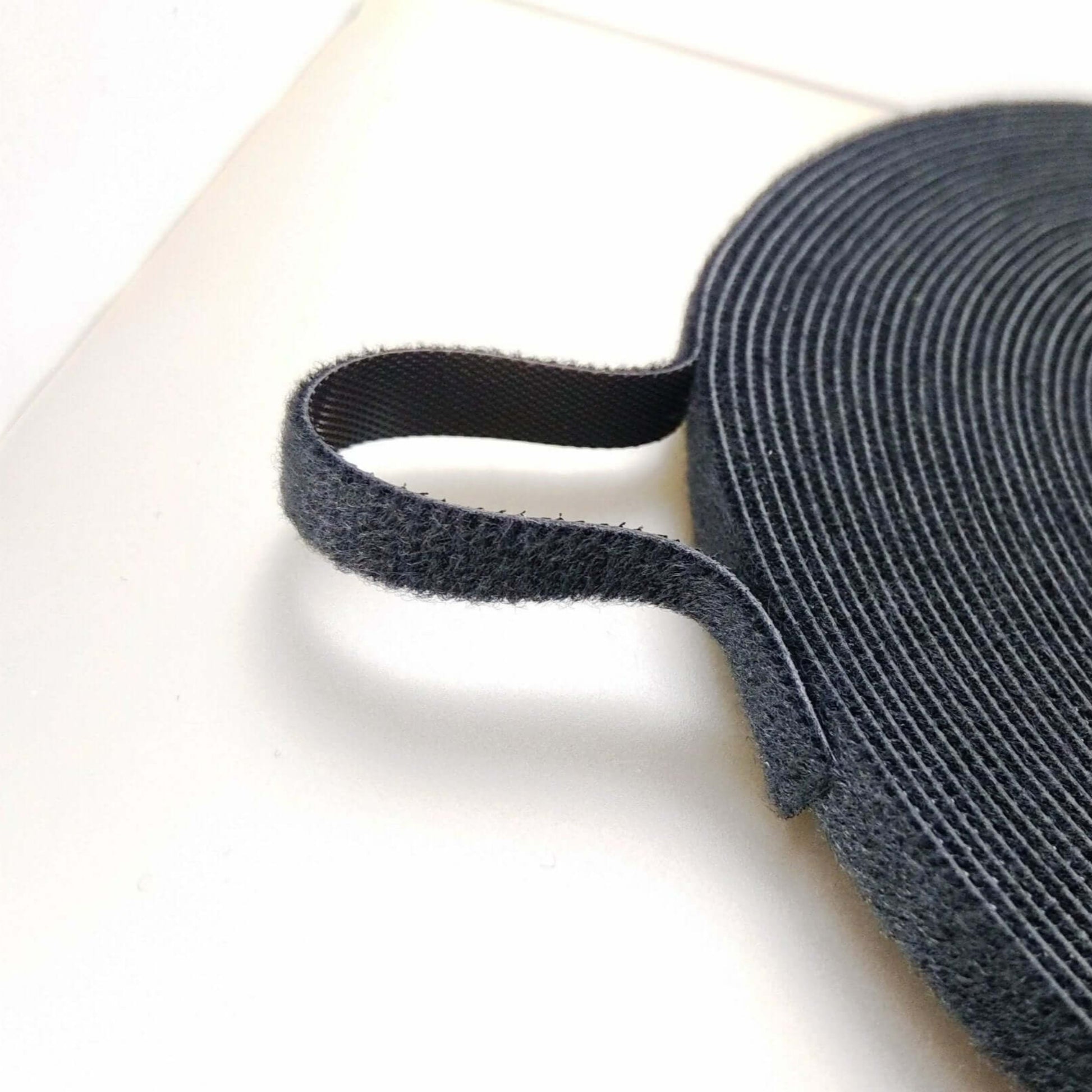 Close-up of 1cm black nylon webbing strap/ribbon, strong self-gripping velcro for DIY craft and sewing.
