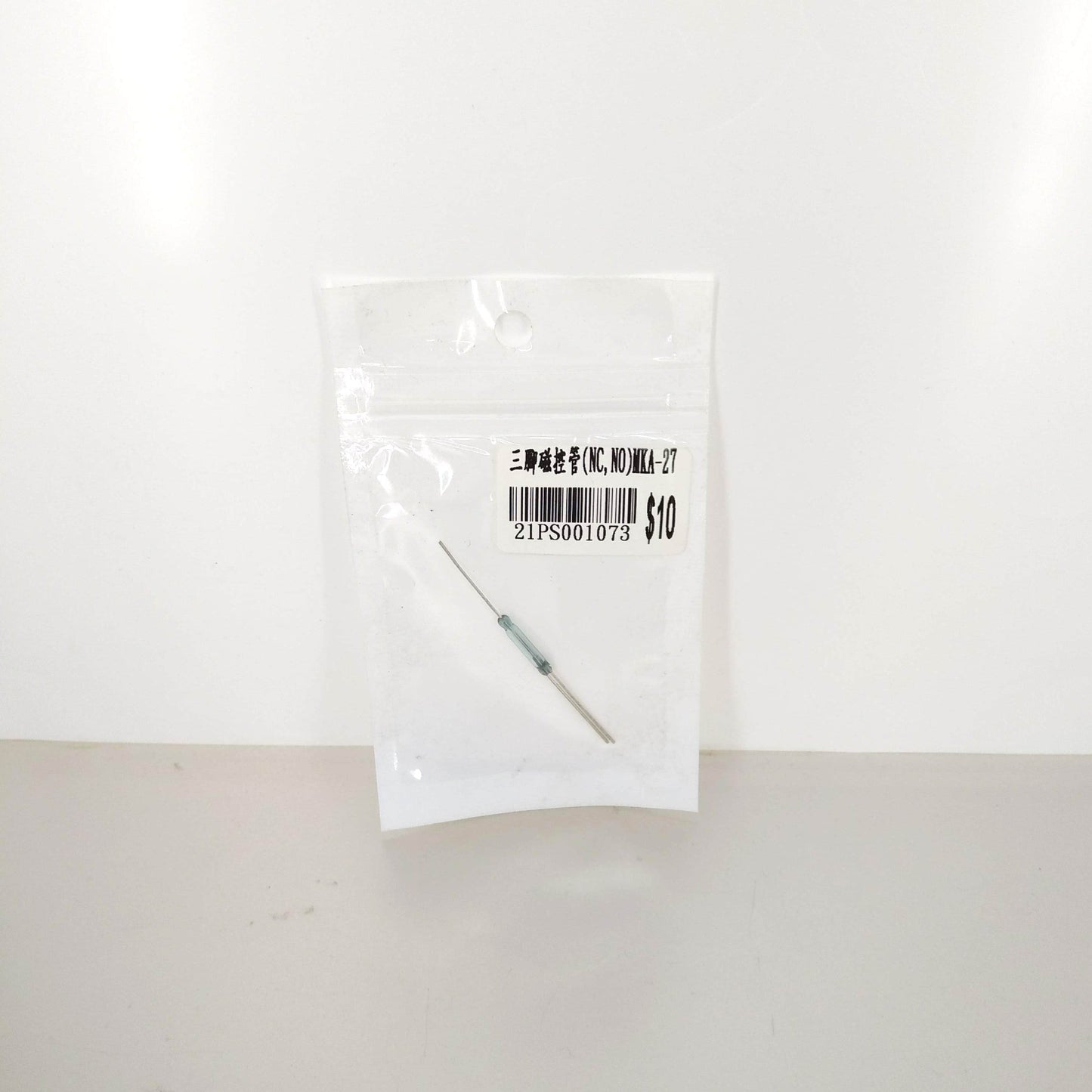 Clear view of the MKA-27 3-Pin Magnetic Reed Switch in packaging.