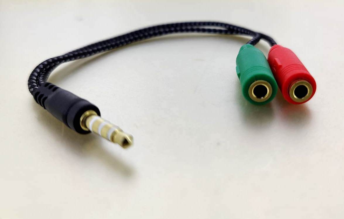 3.5mm headphone and mic splitter adapter with green and red ports for audio connection.