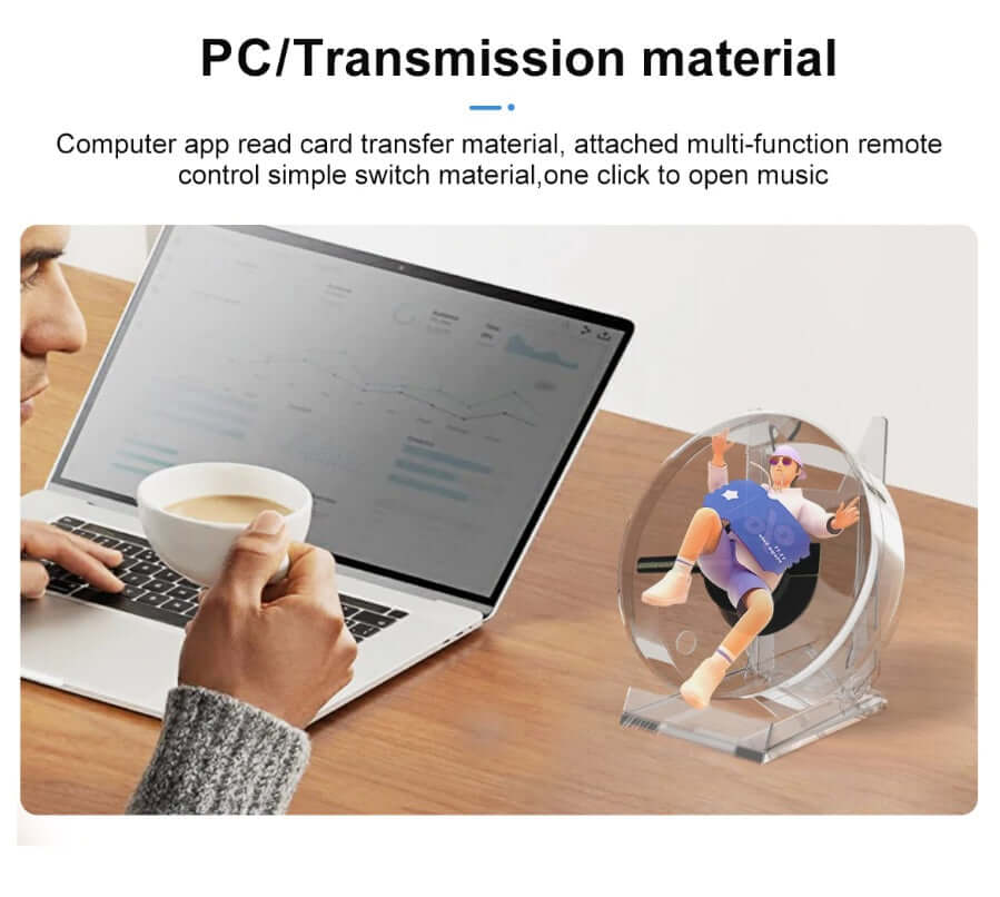 Mini 3D hologram fan displaying a holographic character on a desk next to a laptop, enhancing desktop aesthetics.