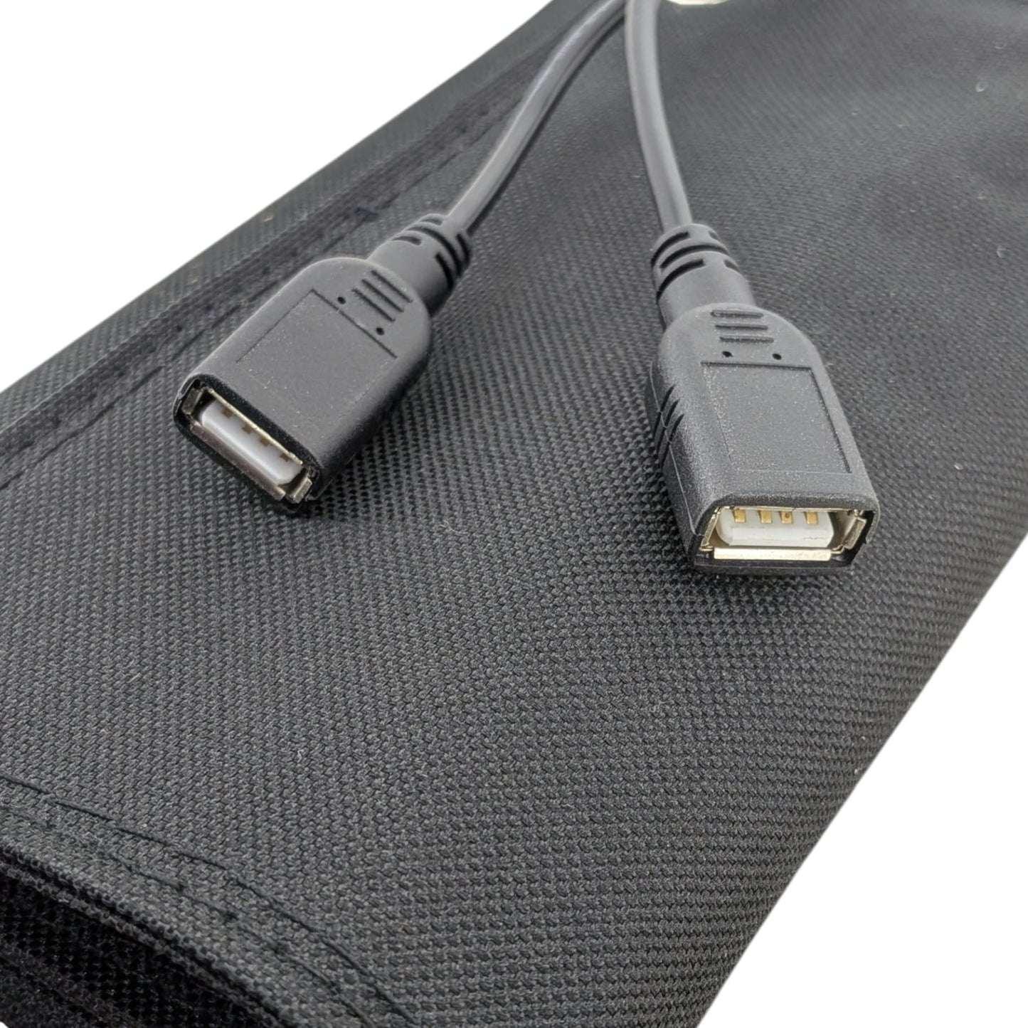 Close-up of the dual 5V USB output ports on the 10W foldable solar panel, ready to charge smartphones and power banks outdoors.