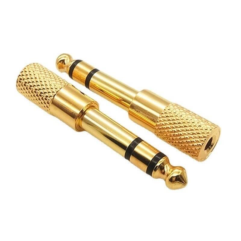 Gold 3.5mm to 6.35mm audio adapter plugs for connecting headphones and audio equipment.
