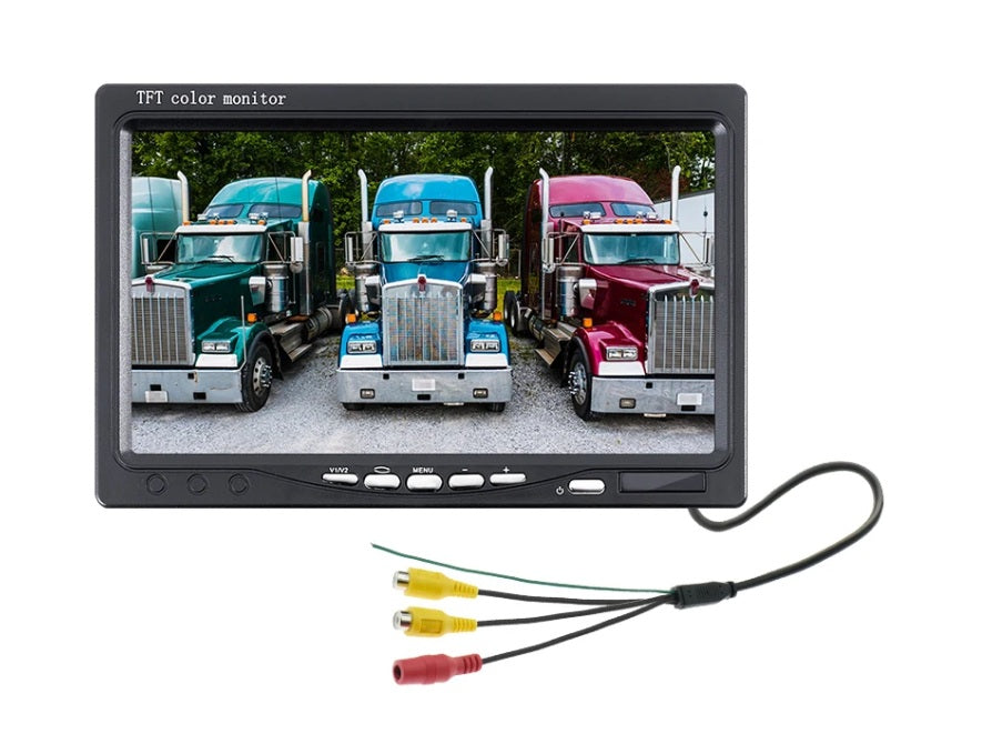 A 7-inch HD TFT color CCTV monitor is shown displaying a live feed of three large trucks parked outdoors, highlighting its capability for vehicle surveillance with multiple camera inputs.