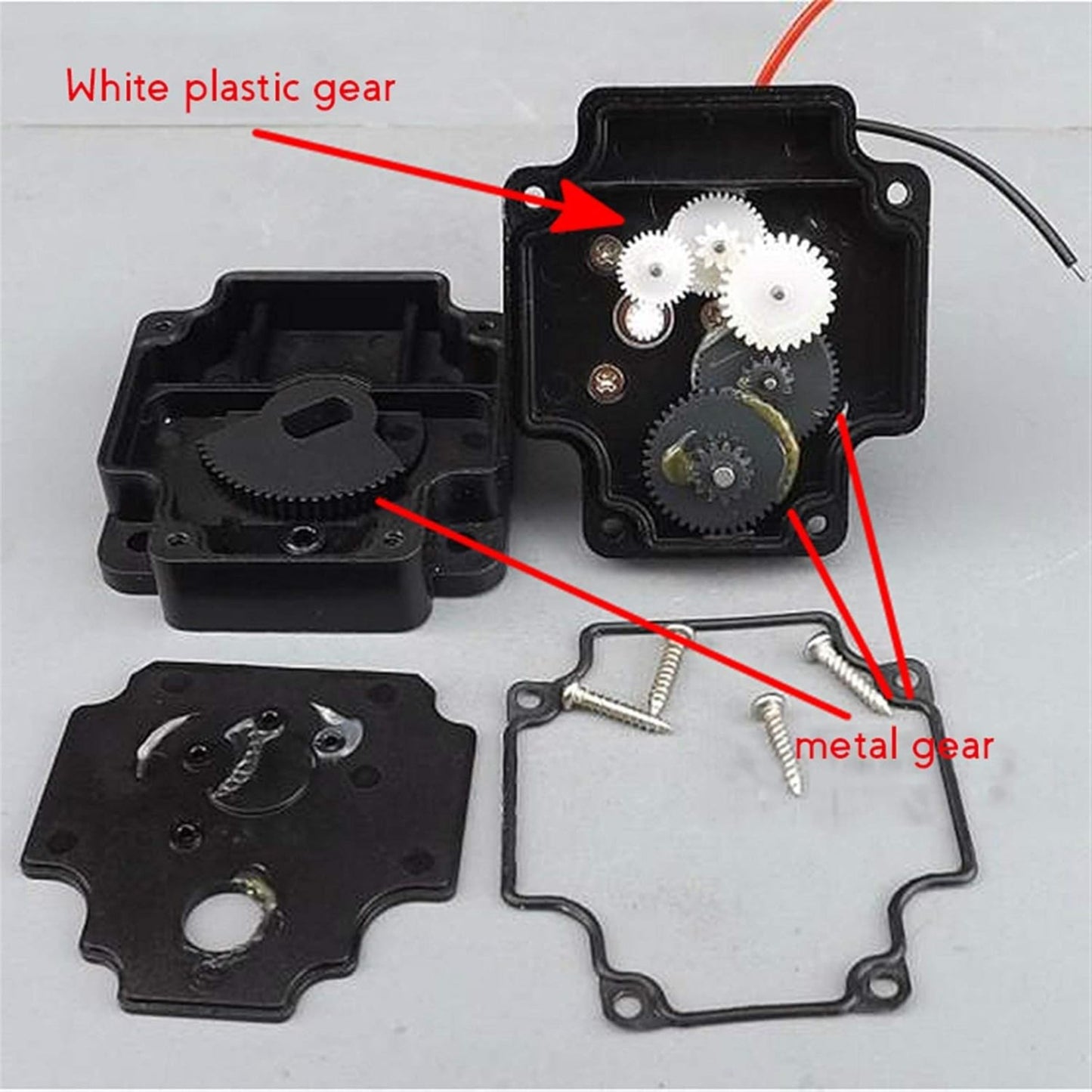 DC 5V motor disassembled view showing white plastic gear and metal gear in gear assembly.