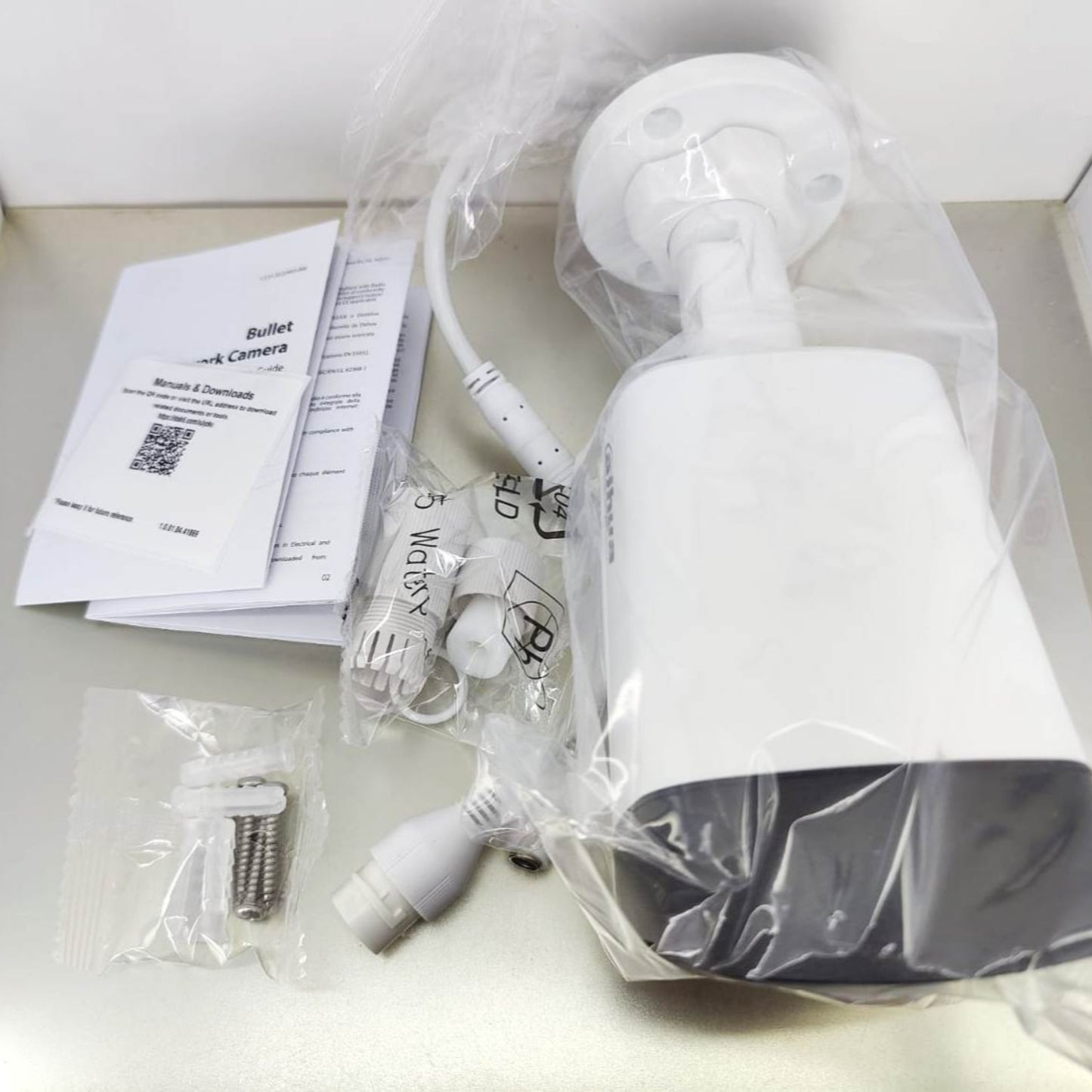 Dahua 2MP Smart Dual Light Bullet Network Camera with accessories and installation manual.