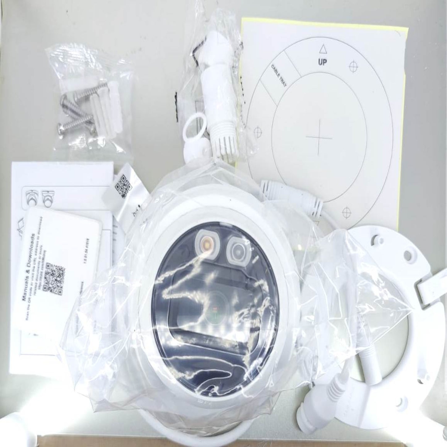Dahua IPC-HDW1239V-A-IL camera components including installation parts and manuals in packaging.
