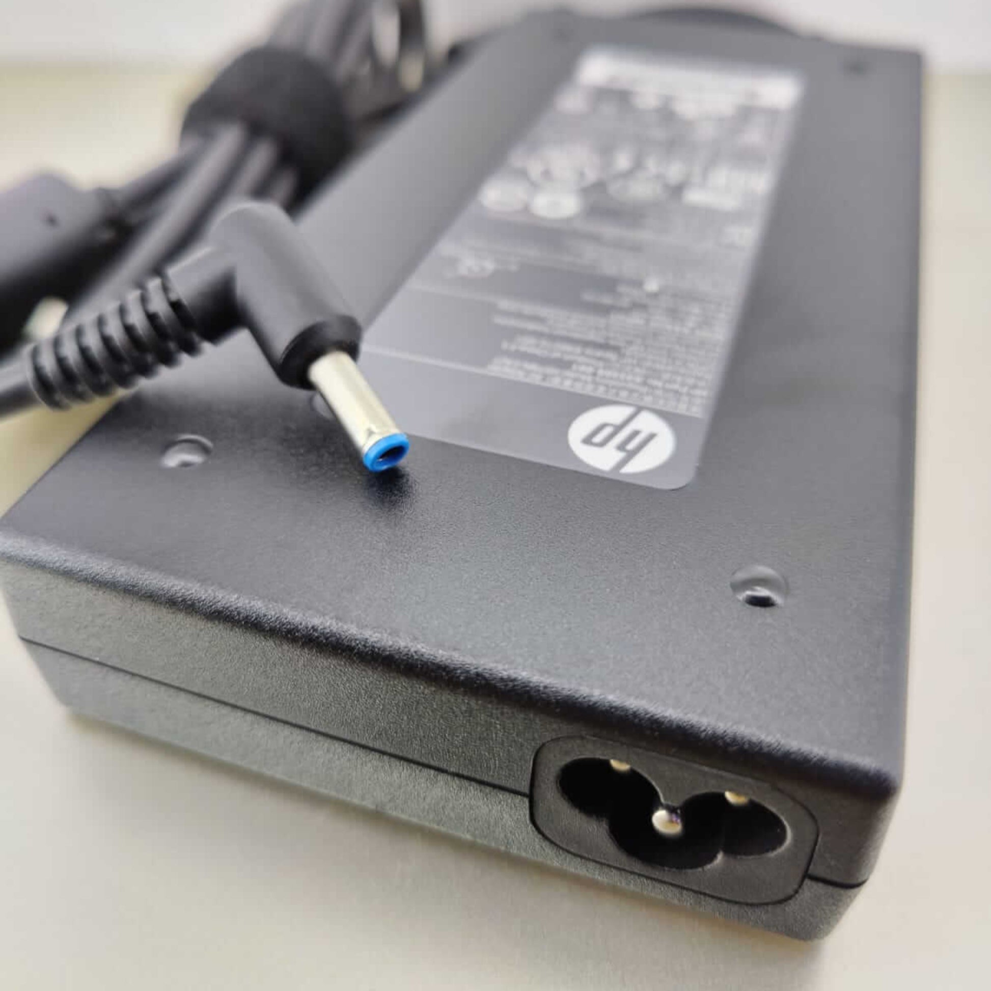HP 150W laptop charger with blue tip connector, power adapter for reliable notebook power supply.