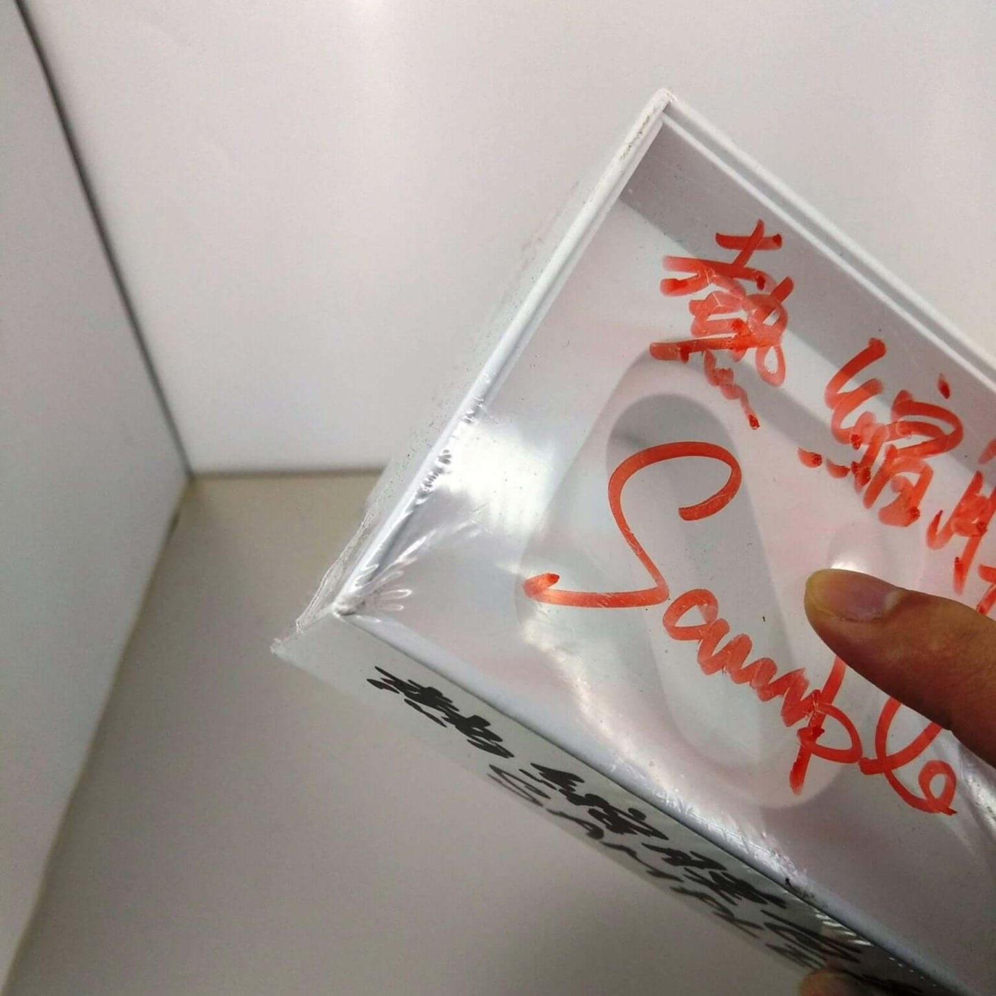 Heat shrink wrap film being used to package a gift or product, showcasing clear, protective wrapping.