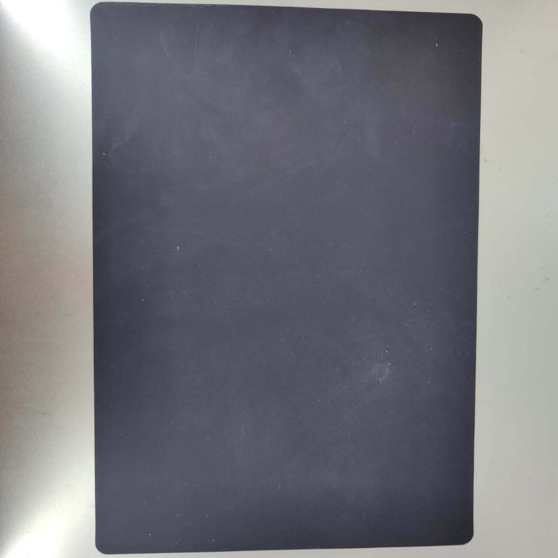 A5 rotary cutting mat in black, ideal for sewing and crafting projects with engravings for precision cutting.