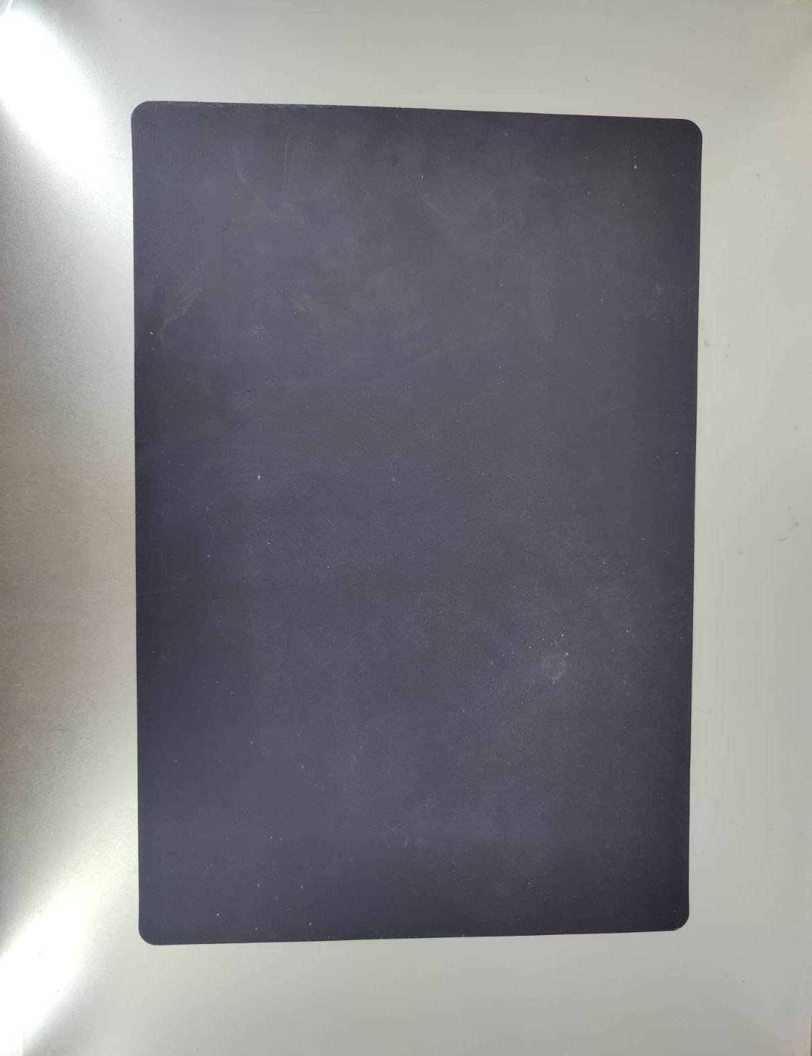 A5 rotary cutting mat in black, ideal for sewing and crafting projects with engravings for precision cutting.