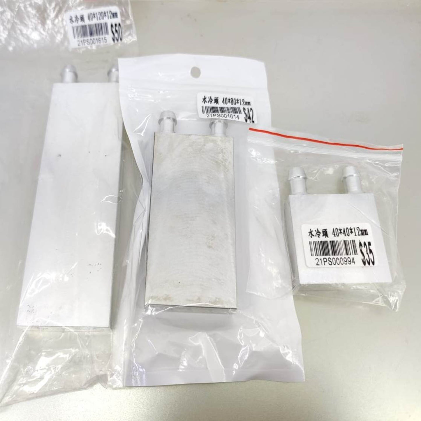 Aluminum water cooling blocks in different sizes: 40x120x12mm, 40x80x12mm, and 40x40x12mm, packaged for thermal management.