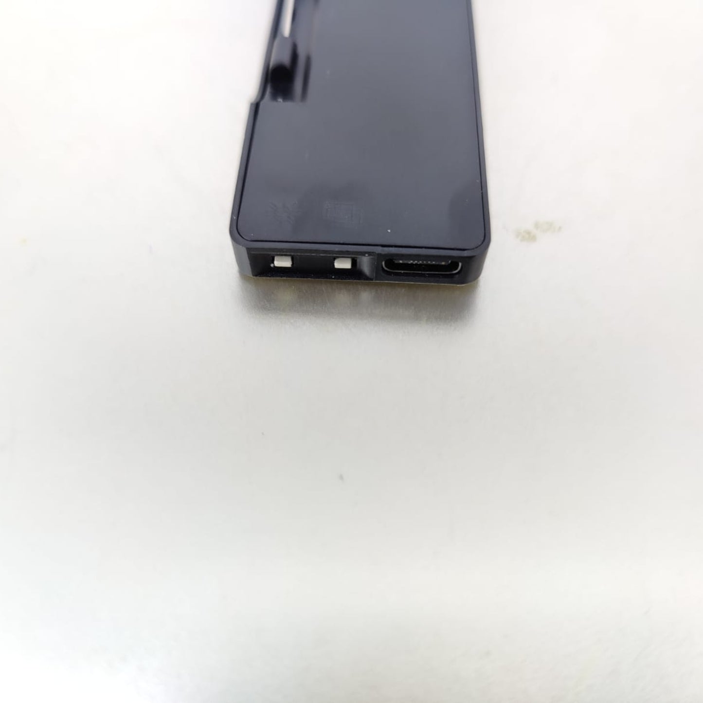 Close-up view of the back of a Wireless Bluetooth LED Name Badge showing USB-C port and programmable interface.