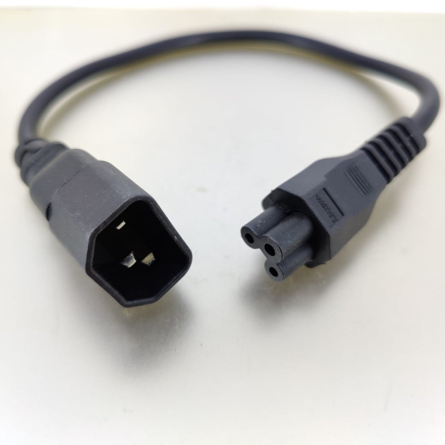 C14 to C5 power adapter cable on a light background, 1ft length for electronics and devices.