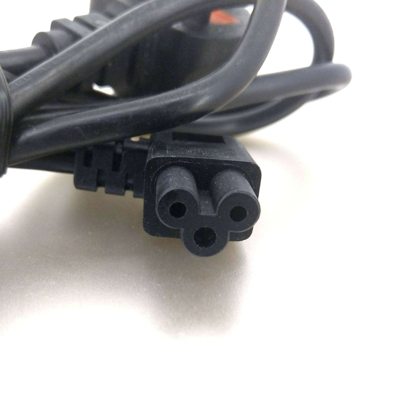 Close-up of the 90-degree right angle IEC C5 "Mickey Mouse" connector plug of a power cable.