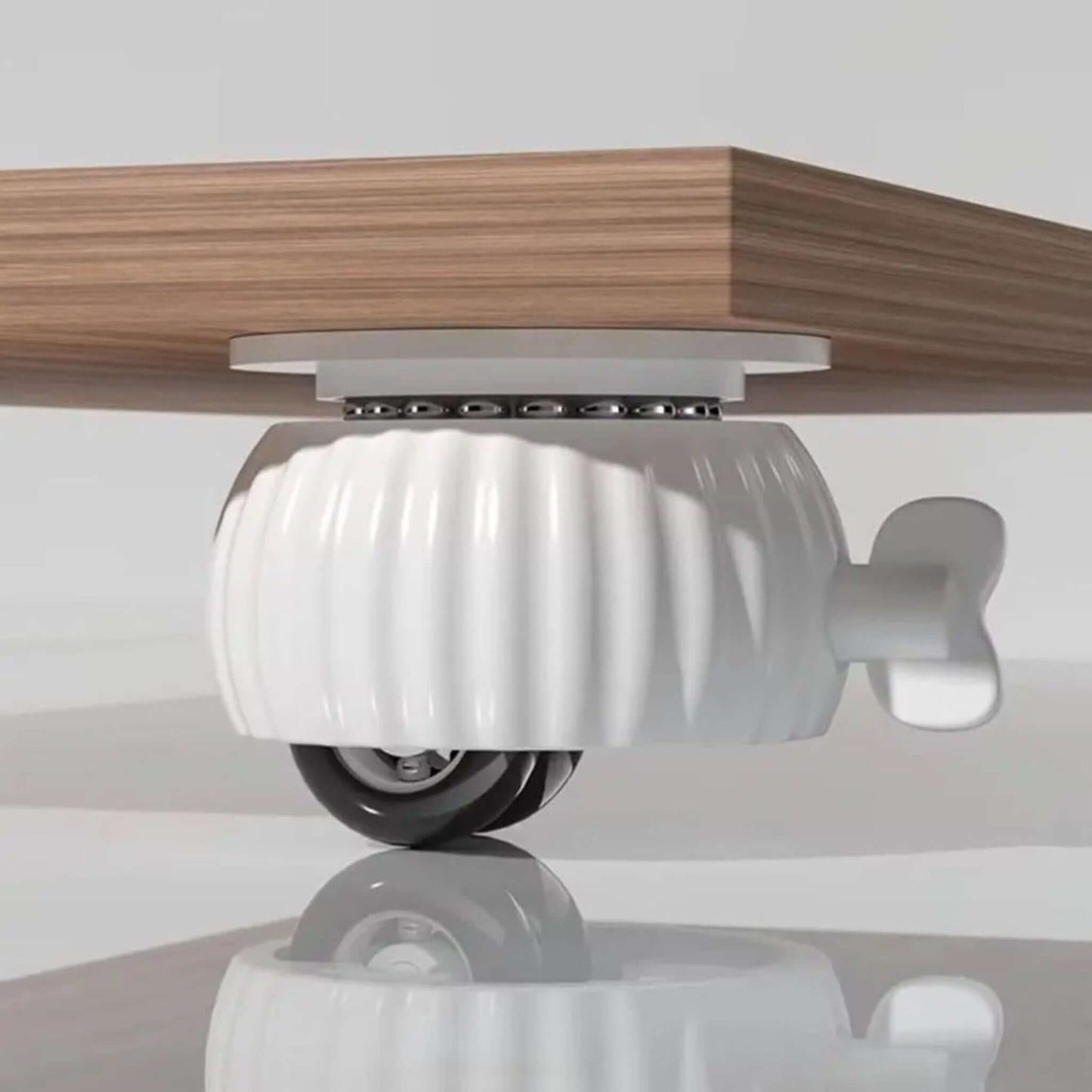 Universal wheel caster with brake and 360° rotation attached to the underside of a wooden furniture piece.
