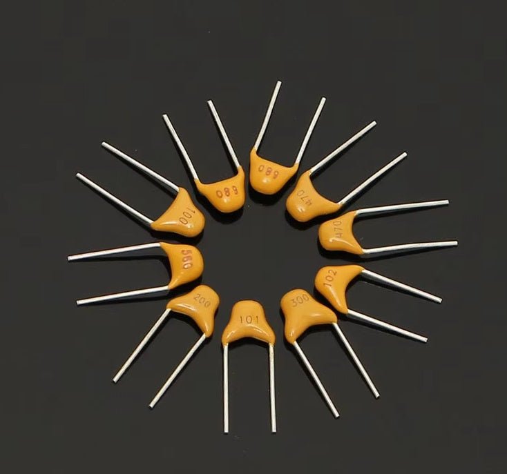 Multilayer ceramic capacitors arranged in a circular pattern, showcasing different values and metal leads.