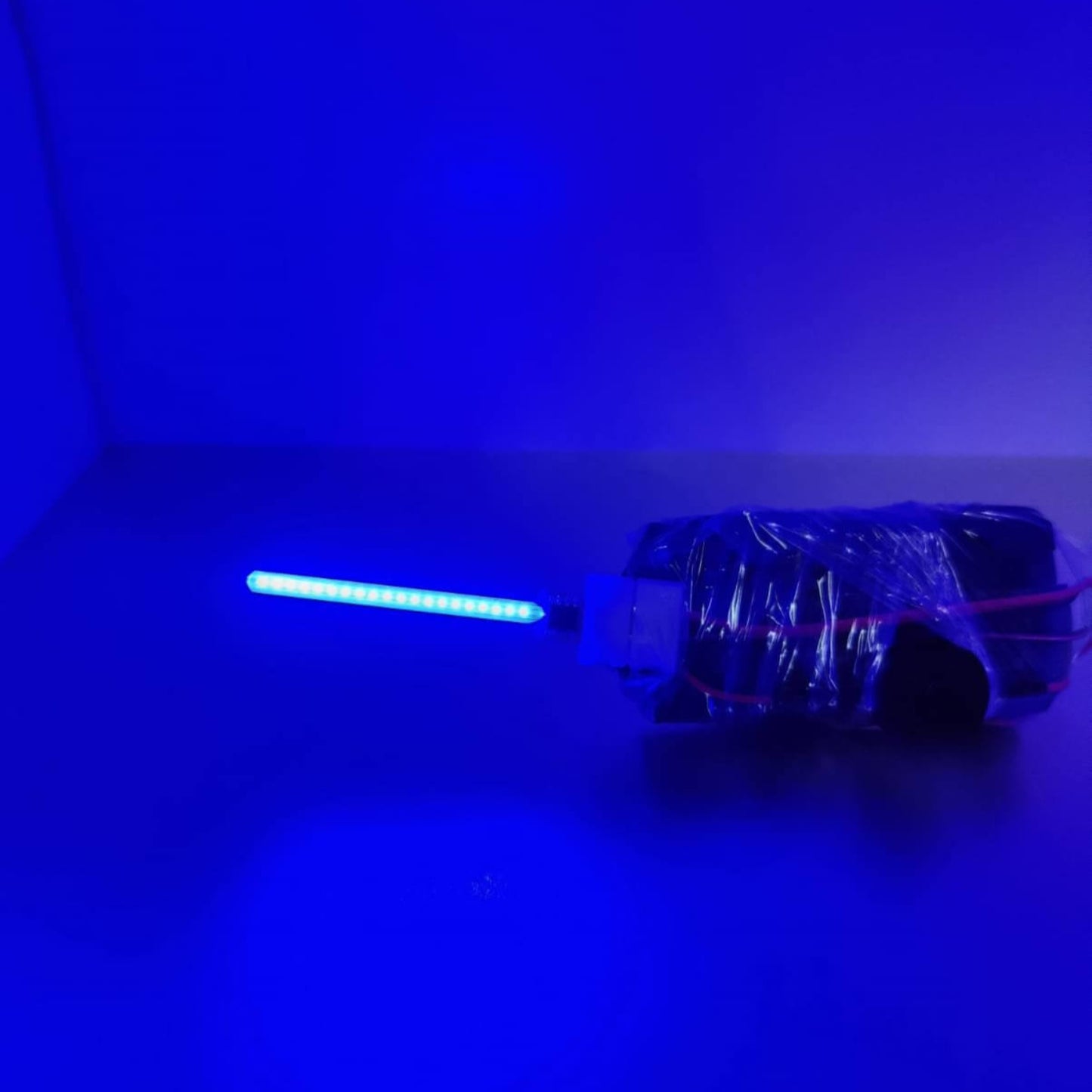 Blue 59mm COB LED Meteor Lamp filament glowing with vibrant light, showcasing modern lighting design.