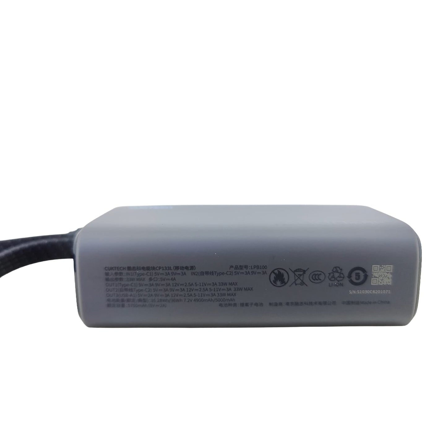 The specification panel on the bottom of the CUKTECH LPB100 power bank, detailing input, output, and capacity information.