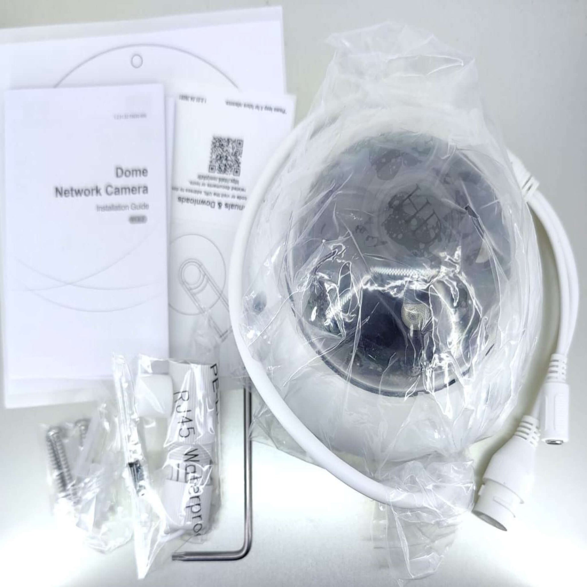 Dahua 2MP WDR IR Dome Network Camera kit with installation guide, mounting hardware, and waterproof RJ45