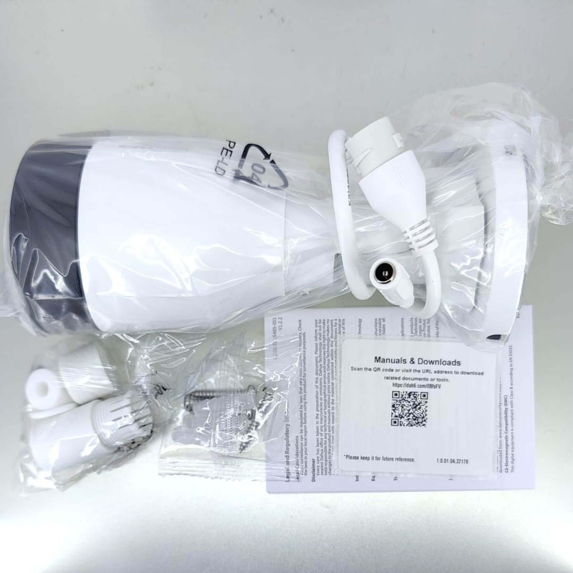 Dahua IPC-HFW1230S1-A-S5 2MP bullet camera packaging, showing camera, manual, and accessories.