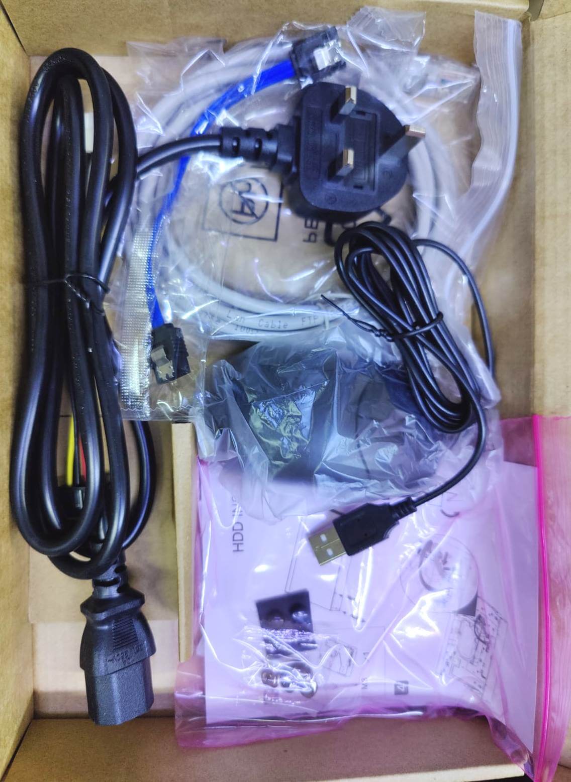 Dahua NVR2108HS-8P-4KS3 accessory kit including power cords, Ethernet cables, and user manual, packaged for installation.
