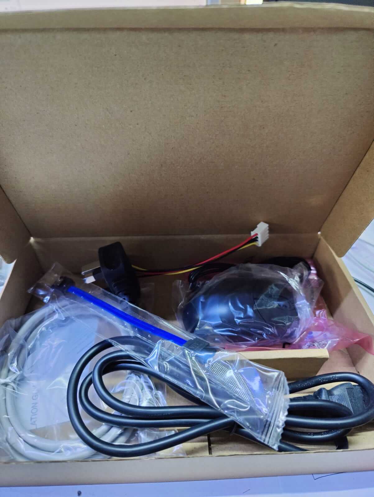 Dahua NVR setup accessories including cables and connectors in a box.