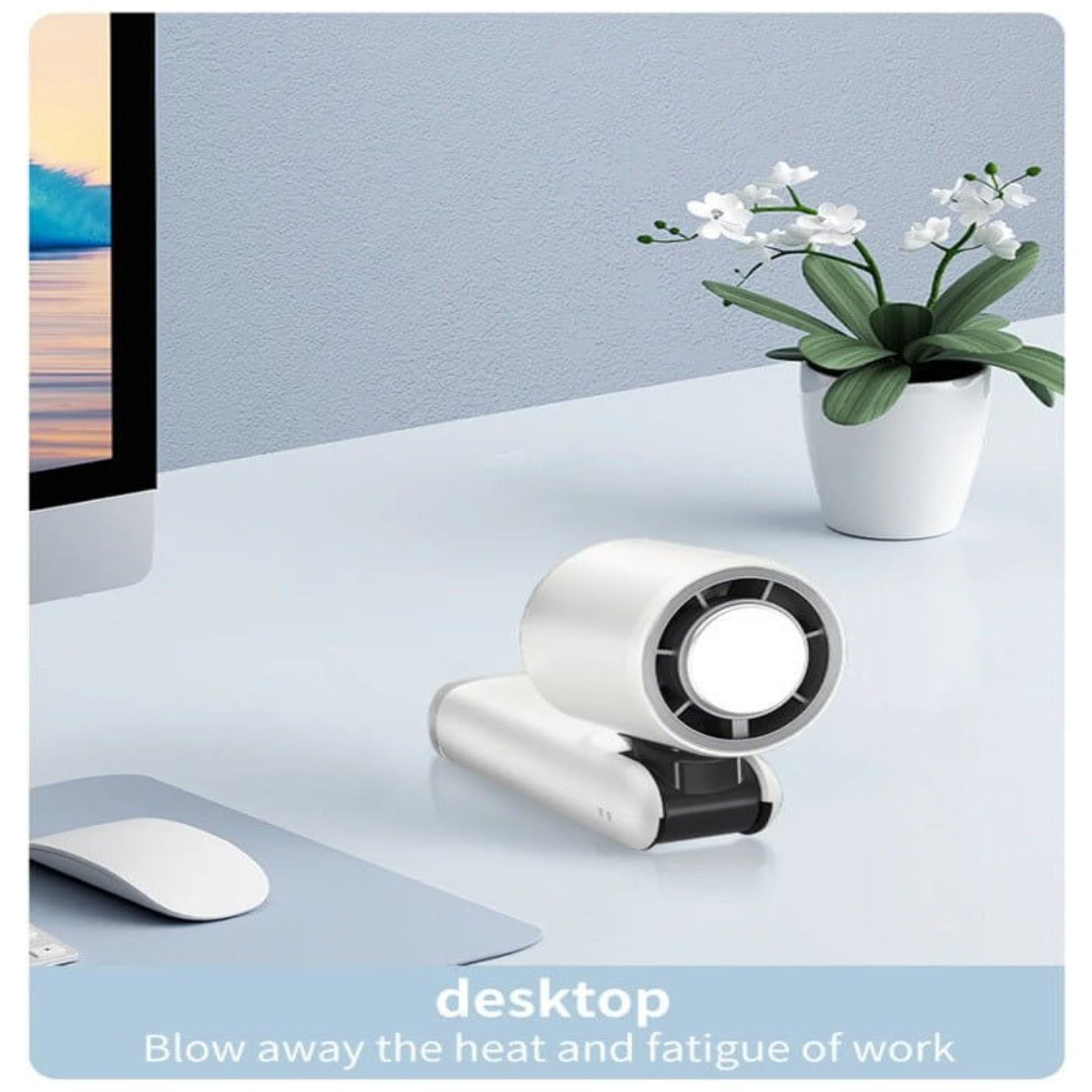 Mini handheld turbofan on a desktop, providing cooling relief and enhancing comfort during work.