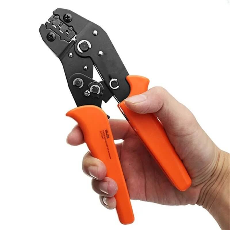 Hand holding a 2.54mm Dupont crimper, demonstrating its ergonomic design and size.