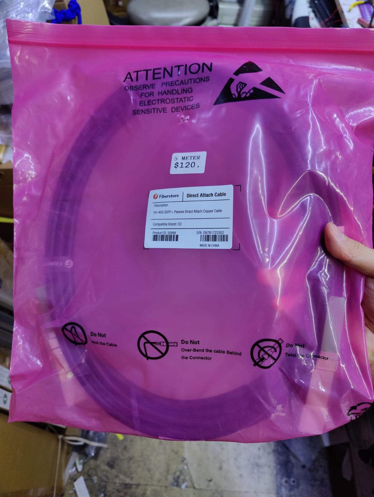Fiberstore 40G QSFP+ Passive DAC Cable in protective pink packaging with price tag of $120.