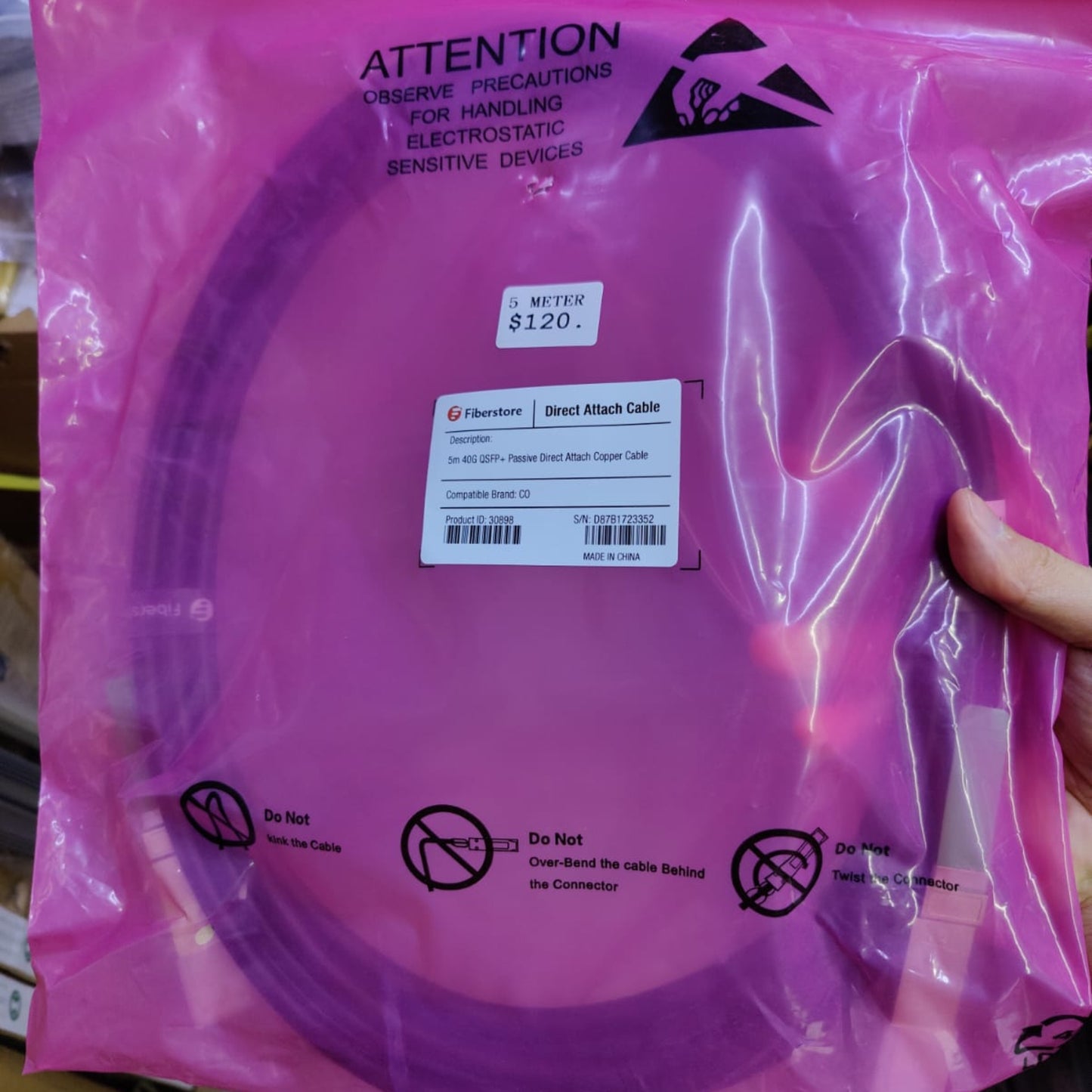 Fiberstore 40G QSFP+ Passive DAC Cable in protective pink packaging with price tag of $120.
