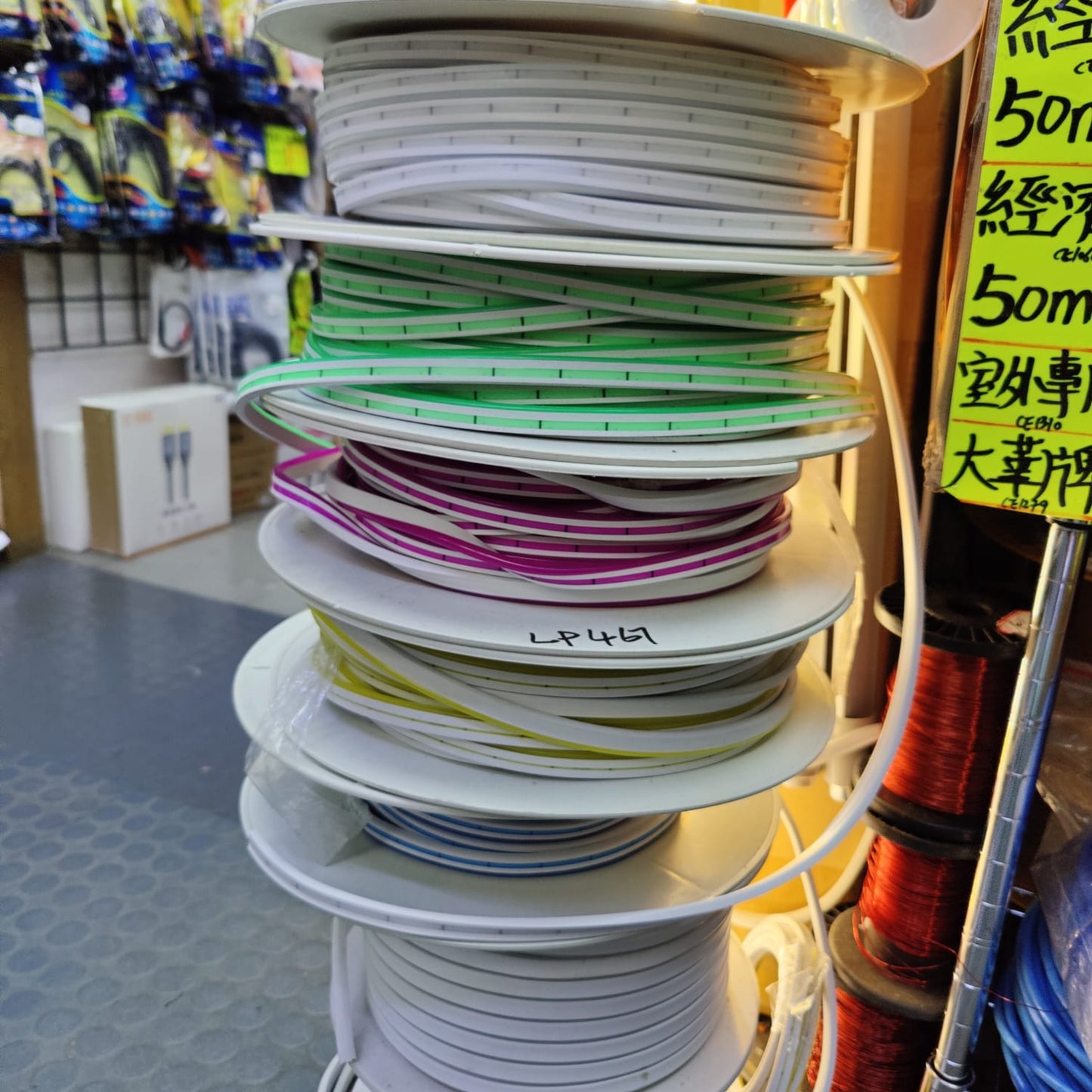 Spools of 12V flexible LED light strips in various colors, showcasing available options.