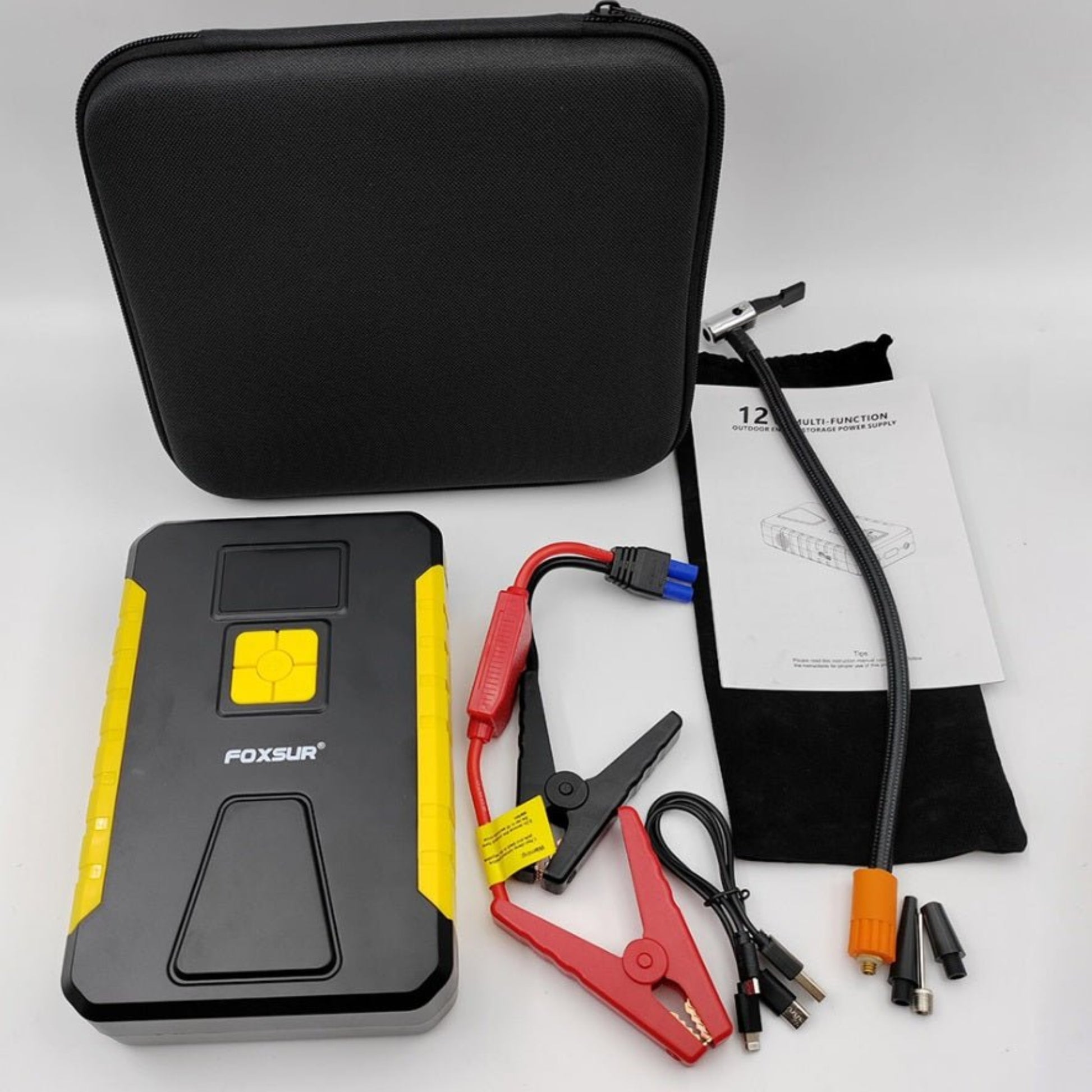 FOXSUR 12V car jump starter and tire inflator with accessories in a compact case, perfect for roadside emergencies.
