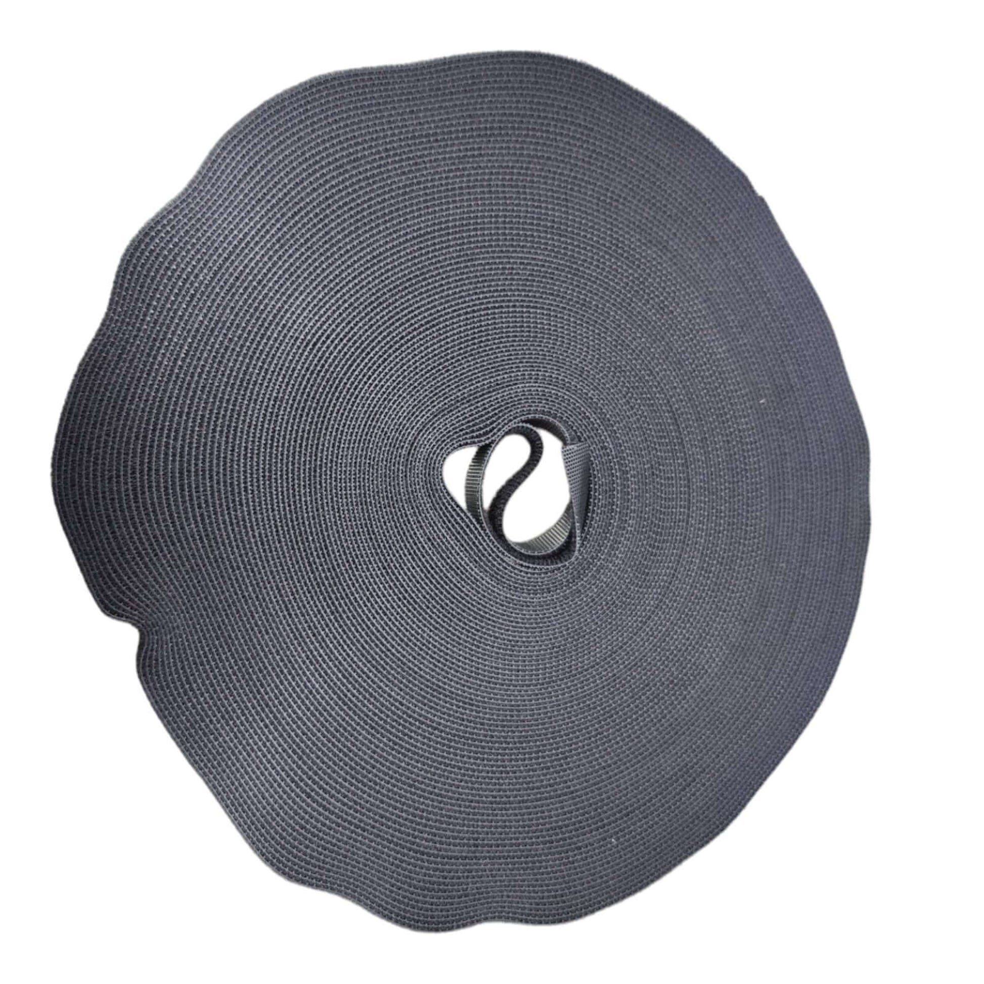 Large roll of dark grey/black nylon hook and loop fastener tape, durable and reusable strap for various accessories.