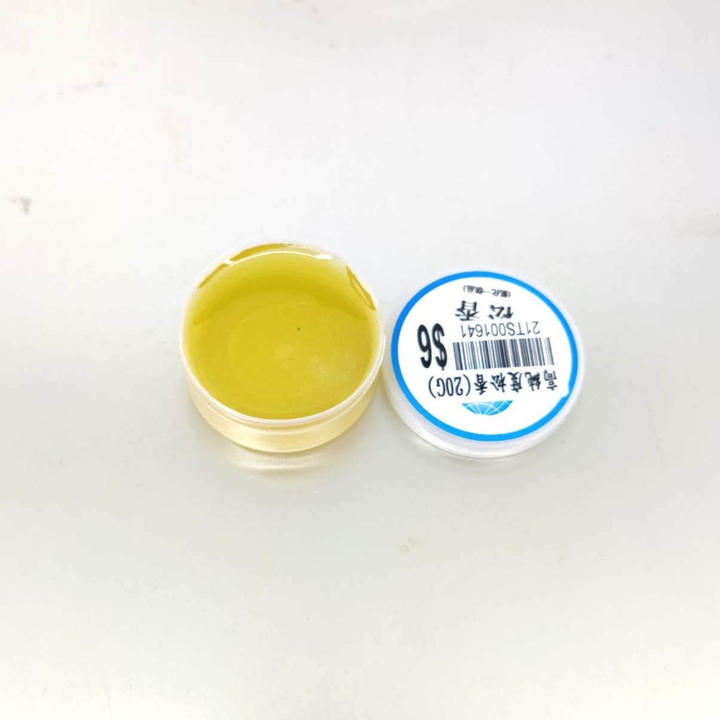 Open container of 20g rosin solder flux paste for electronics soldering applications.