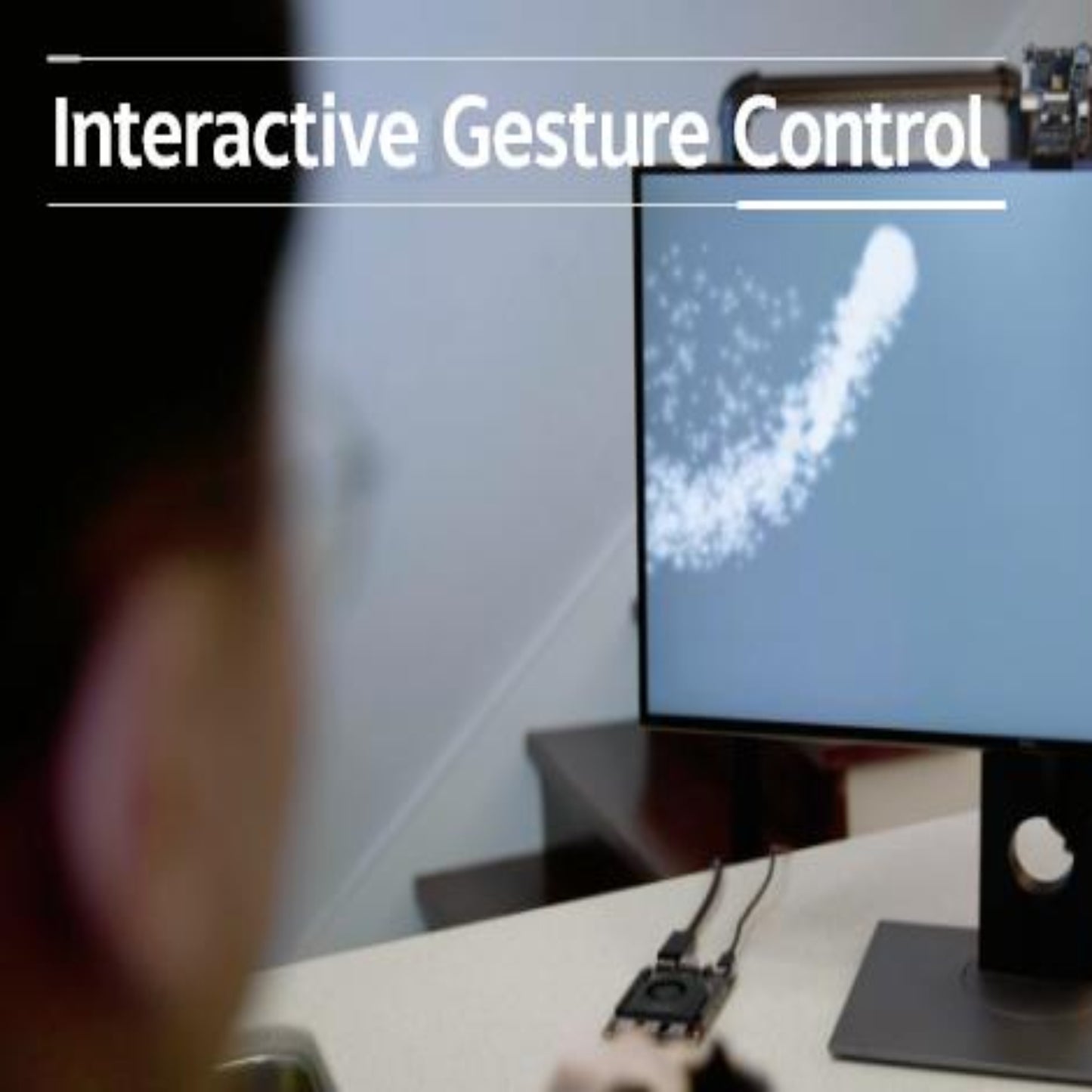 User interacting with a monitor displaying interactive gesture control technology.