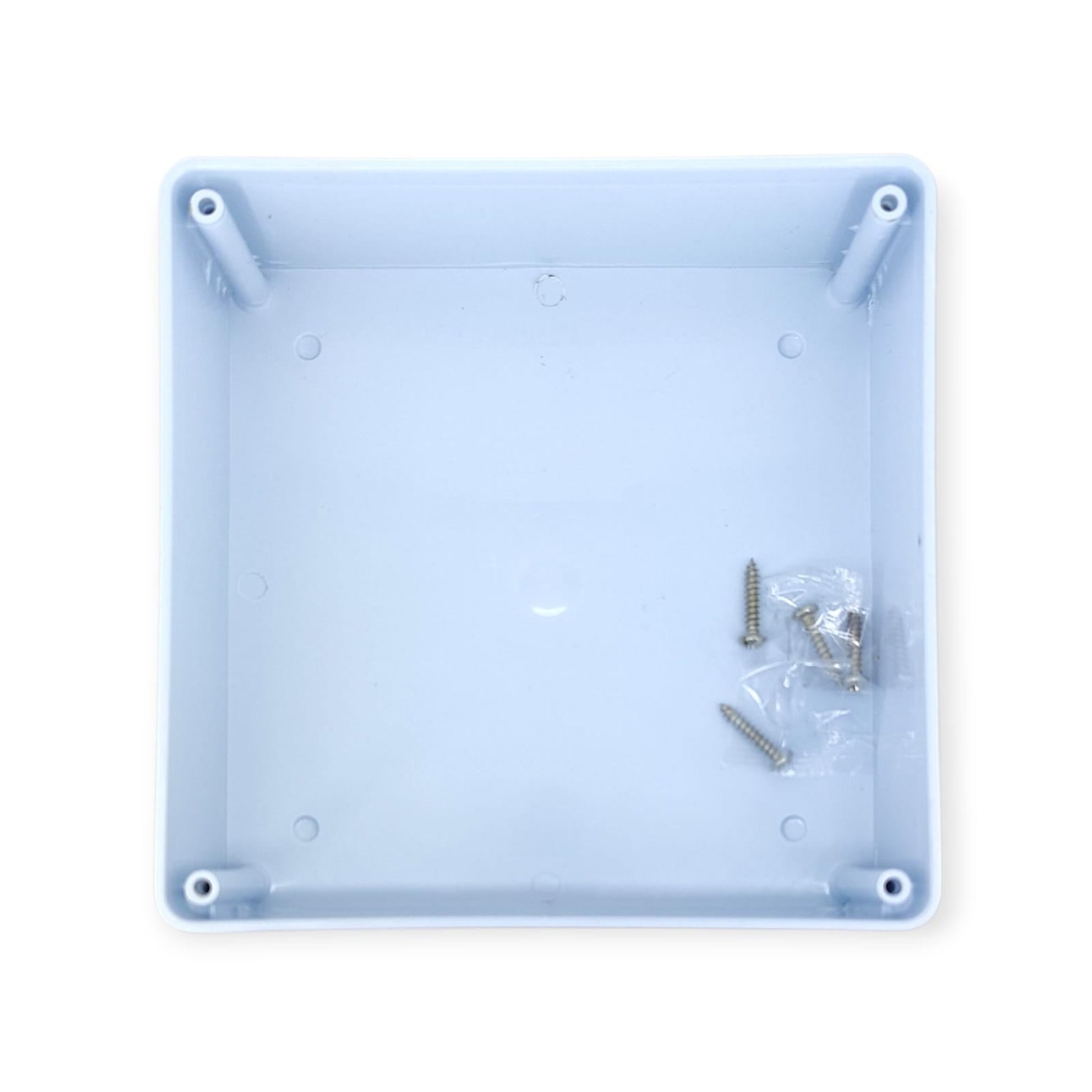 Inside view of the waterproof junction box base, showing internal mounting posts and a packet of screws.