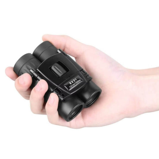 Compact 8x21 mini binoculars held in hand, ideal for bird watching, concerts, and sports.
