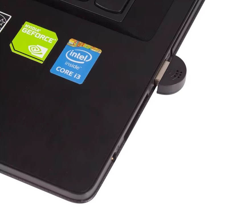 Close-up of a laptop showing NVIDIA GeForce and Intel Core i3 stickers on the surface.