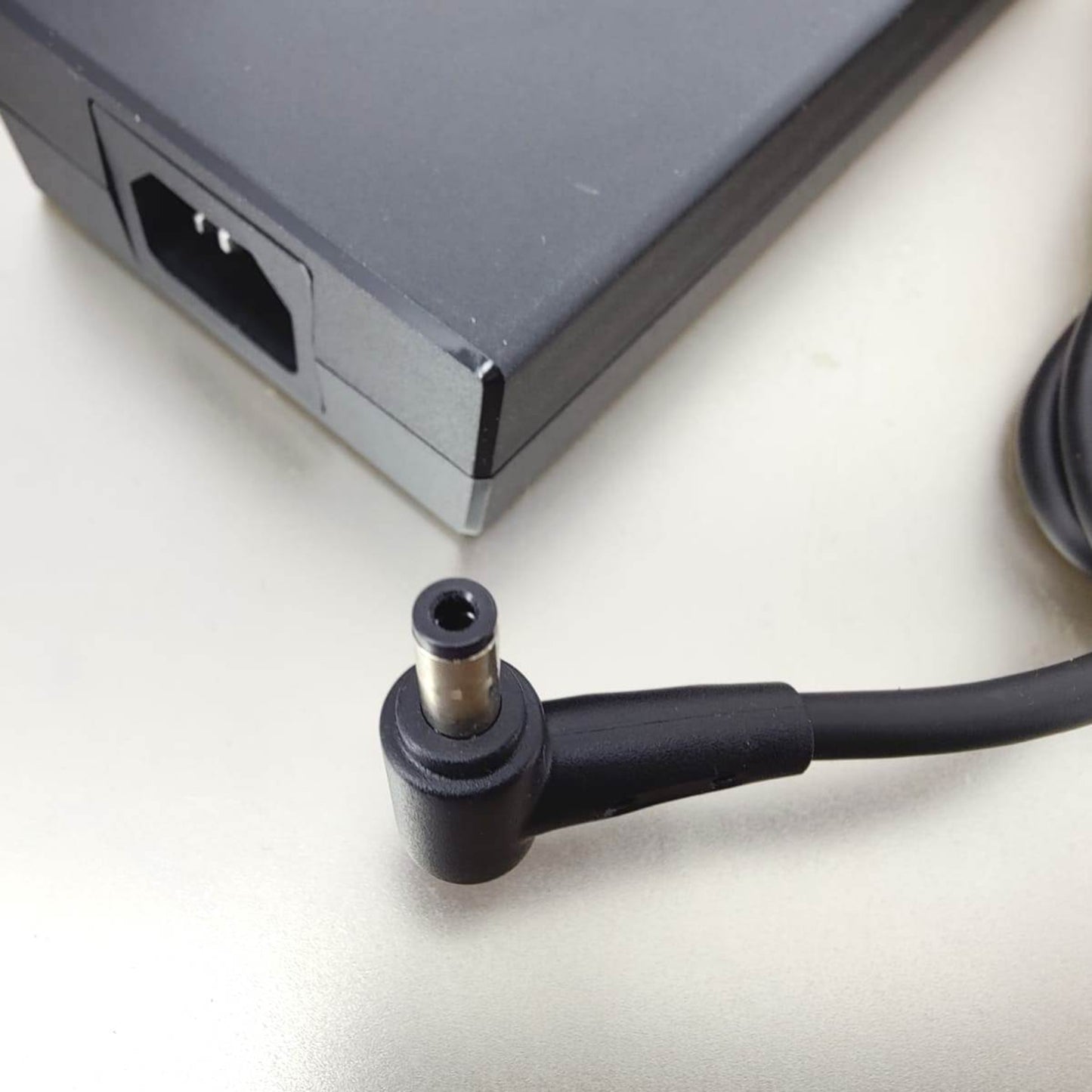 Close-up of the L-tip DC output connector for MSI 230W laptop power adapter.