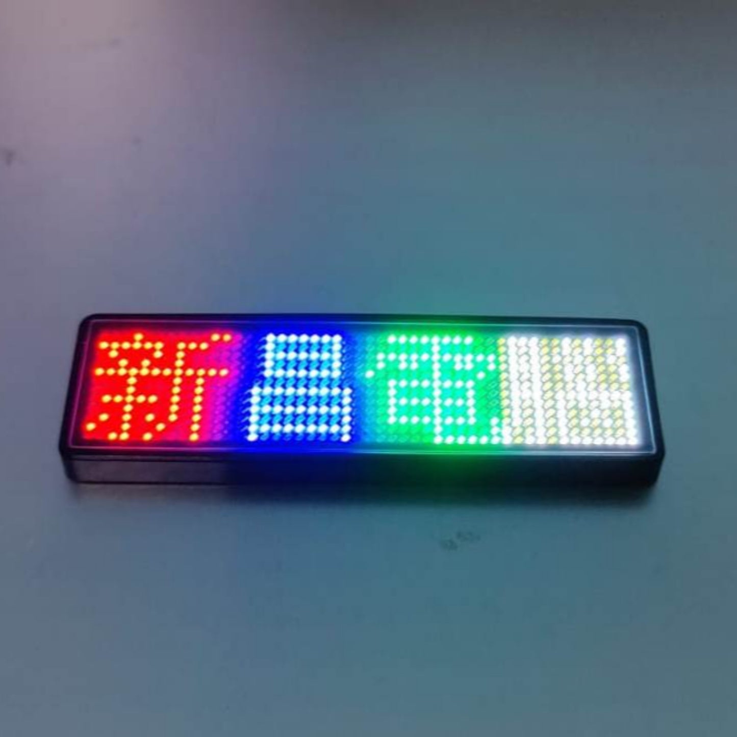 Multicolor Bluetooth LED name badge displaying programmable text, perfect for business use and easy wireless control.