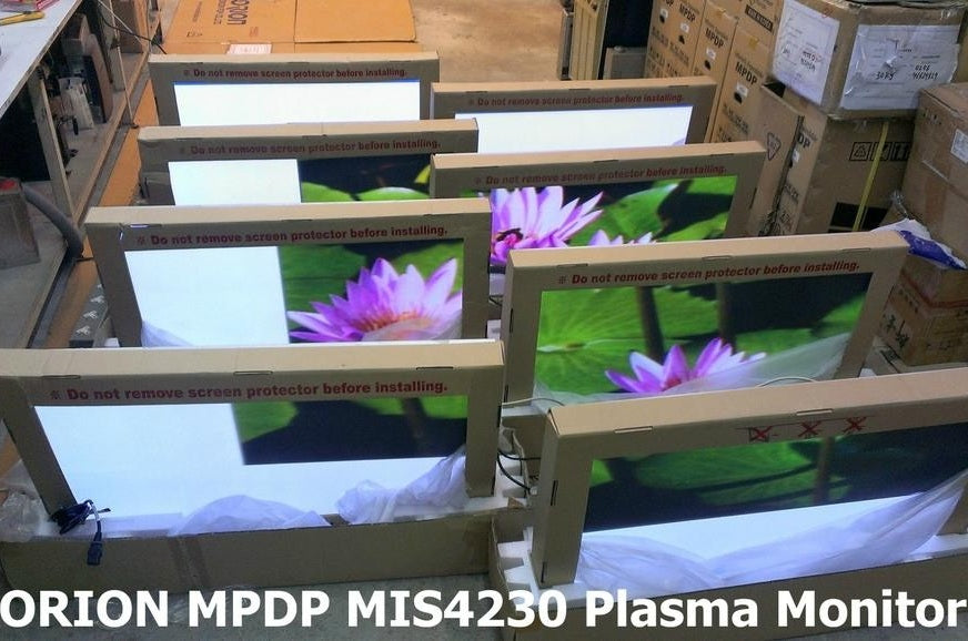 Multiple ORION MPDP 42-inch seamless bezel plasma displays in boxes, set up for video wall installation.