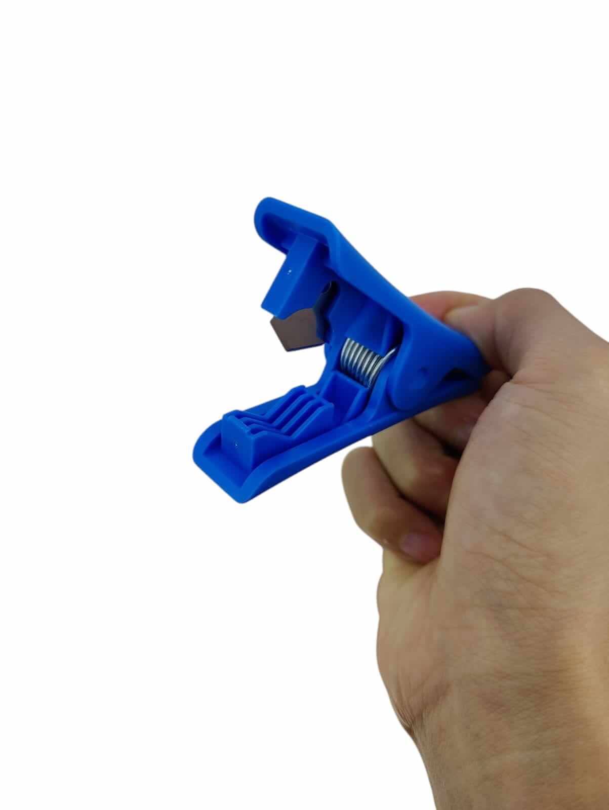 Hand holding a blue professional pneumatic tube cutter for precision cutting of air hoses.