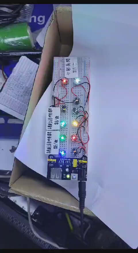 Breadboard with illuminated LEDs and wiring for electronic projects and prototypes.