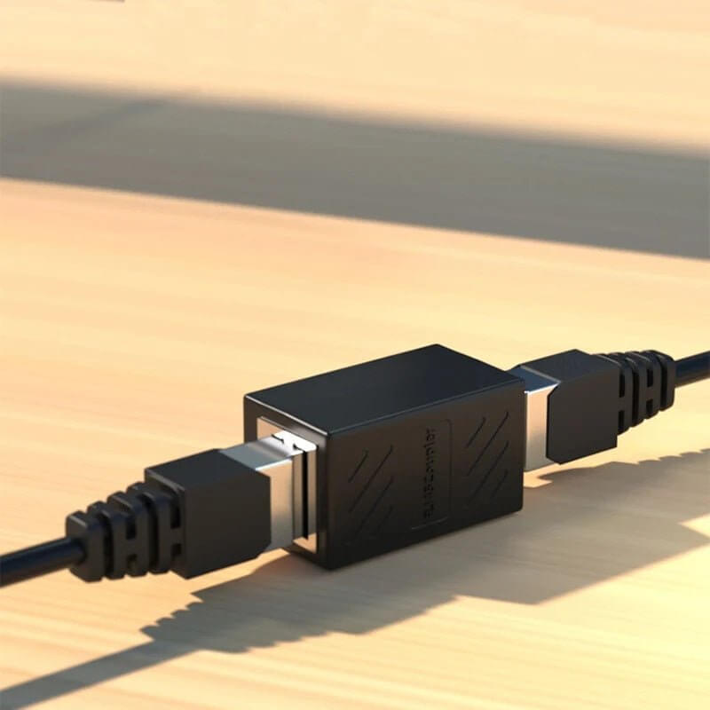 RJ45 Connector F/F network adapter in black for extending Ethernet cable connections.